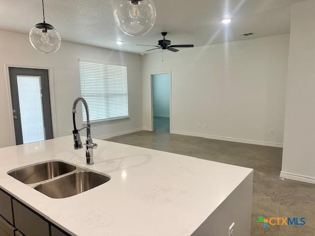 2225 Wooster St, Nolanville, TX 76559 - kitchen with open floor plan, light countertops, pendant lighting, a ceiling fan, and finished concrete flooring
