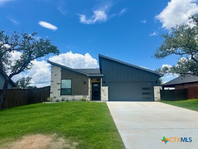 2225 Wooster St, Nolanville, TX 76559 - view of front of property with a garage, driveway, and board and batten siding