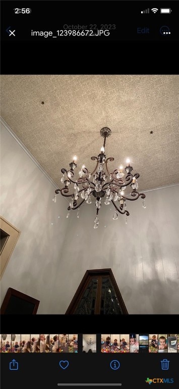 details featuring a textured ceiling and a chandelier