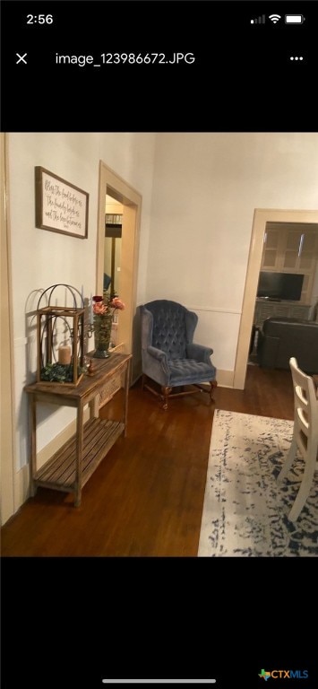 corridor with dark hardwood / wood-style flooring