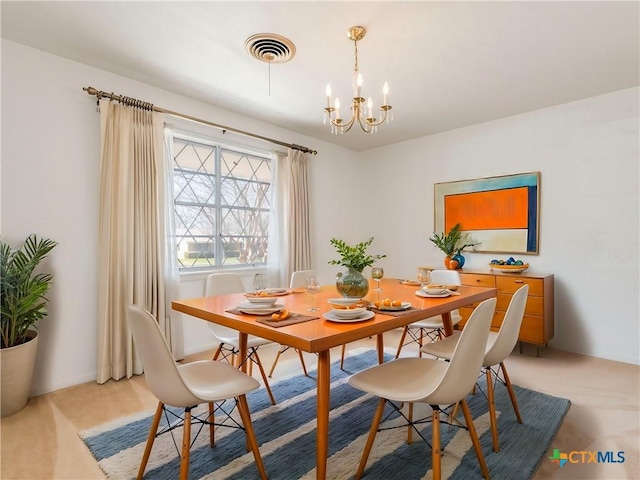 dining area with visible vents and a chandelier