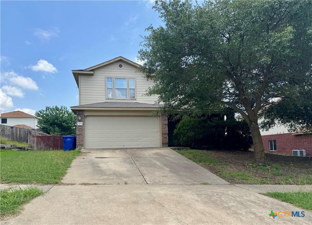 2204 Vernice Dr, Copperas Cove, TX 76522 - view of front of home with a garage, brick siding, and driveway