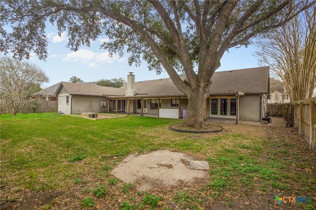 back of property featuring a yard and a patio area