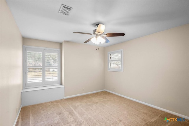 carpeted spare room with ceiling fan