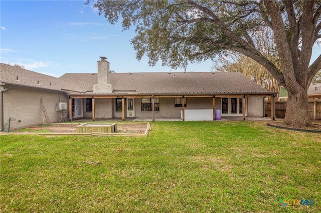 back of property featuring a yard and a wall mounted AC