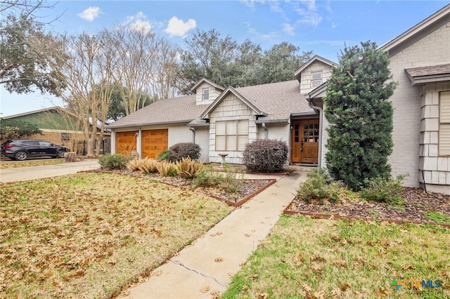 view of front of home with a garage and a front yard