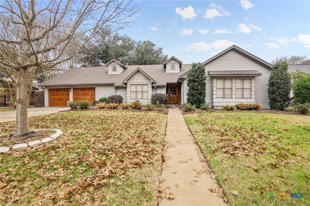 ranch-style home with a garage and a front yard