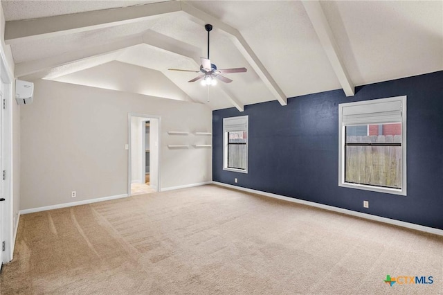 empty room with ceiling fan, carpet flooring, lofted ceiling with beams, and a wall unit AC