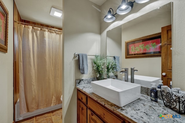 bathroom with vanity and shower / bath combo with shower curtain