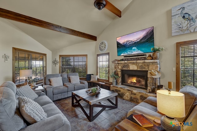 living room featuring beamed ceiling, a stone fireplace, and high vaulted ceiling