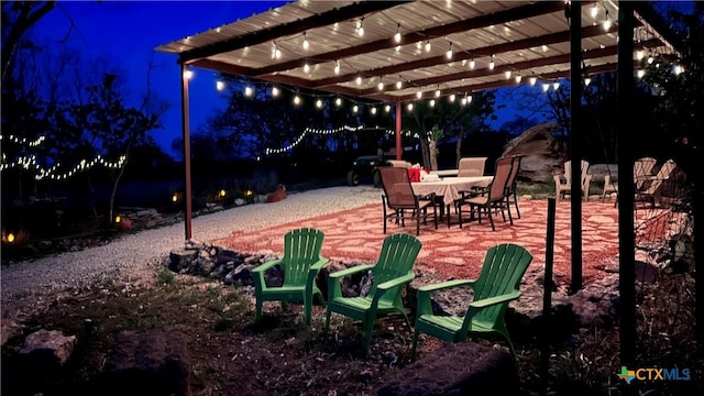 patio at twilight featuring a pergola