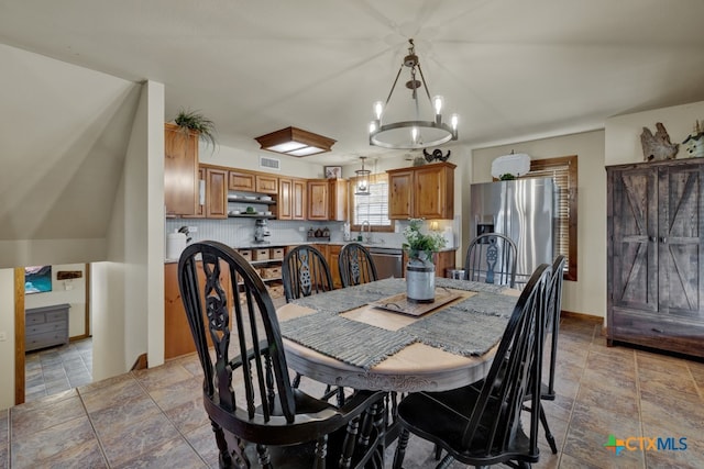 dining area with a chandelier and sink