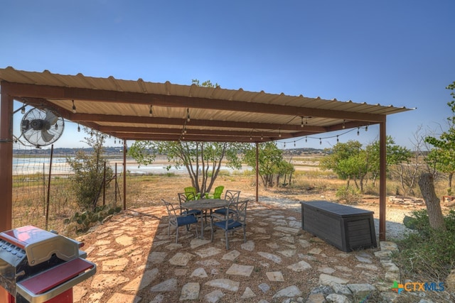 view of patio featuring a grill and a water view