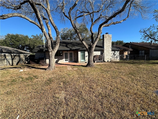 rear view of property featuring a yard