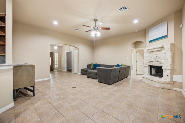 2291 Frontier, Spring Branch, TX 78070 - living area with arched walkways, ceiling fan, light tile patterned flooring, a fireplace, and recessed lighting