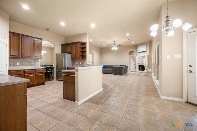 2291 Frontier, Spring Branch, TX 78070 - kitchen featuring open shelves, freestanding refrigerator, arched walkways, backsplash, and recessed lighting
