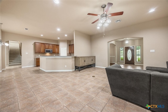 2291 Frontier, Spring Branch, TX 78070 - living room with arched walkways, a ceiling fan, light tile patterned flooring, stairway, and recessed lighting