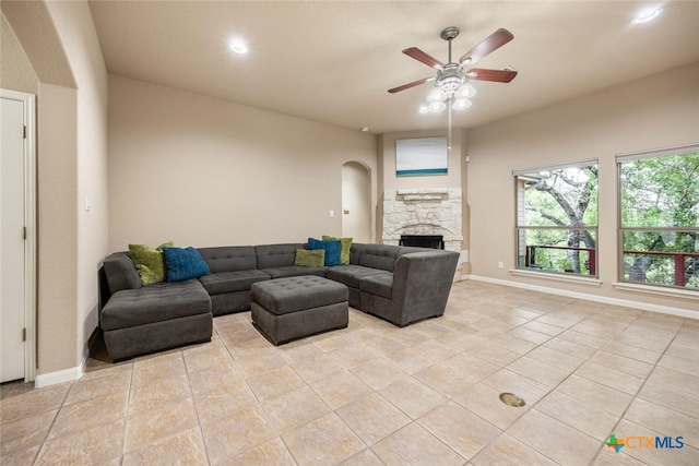 2291 Frontier, Spring Branch, TX 78070 - living area with ceiling fan, light tile patterned floors, arched walkways, a stone fireplace, and recessed lighting
