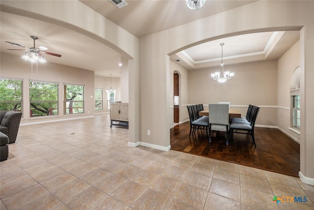 2291 Frontier, Spring Branch, TX 78070 - tiled dining room with arched walkways, a chandelier, and a ceiling fan