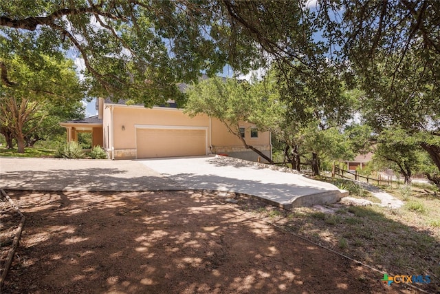 2291 Frontier, Spring Branch, TX 78070 - view of front facade featuring concrete driveway, an attached garage, and stucco siding