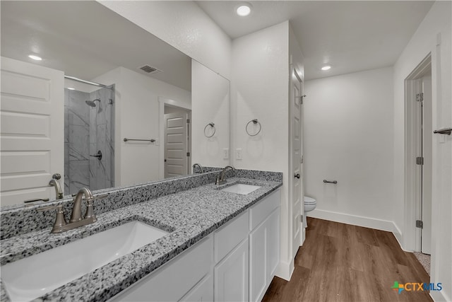 bathroom featuring vanity, hardwood / wood-style flooring, toilet, and an enclosed shower