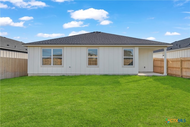 rear view of house with a yard