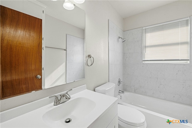 full bathroom with tiled shower / bath combo, toilet, and vanity