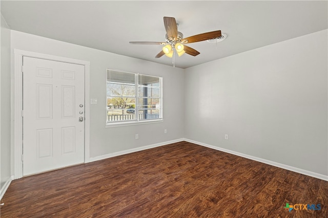 spare room featuring ceiling fan and dark wood-type flooring