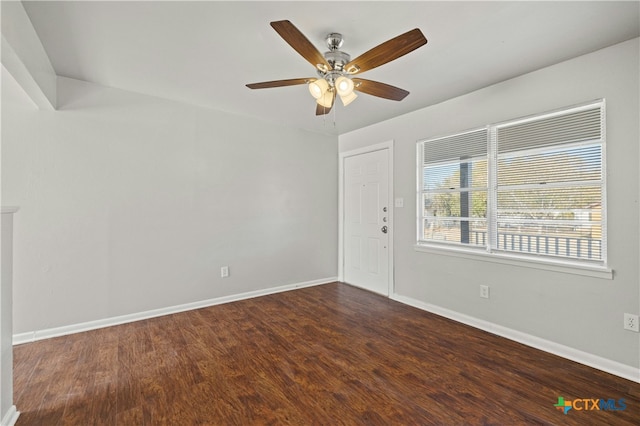 spare room with ceiling fan and dark wood-type flooring