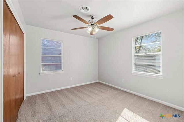 unfurnished bedroom with ceiling fan, a closet, and carpet