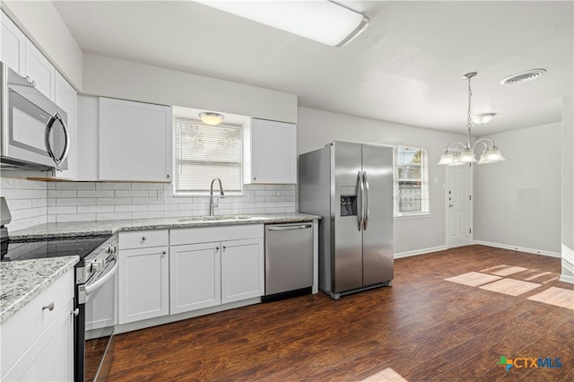 kitchen featuring tasteful backsplash, stainless steel appliances, dark wood-type flooring, sink, and white cabinets