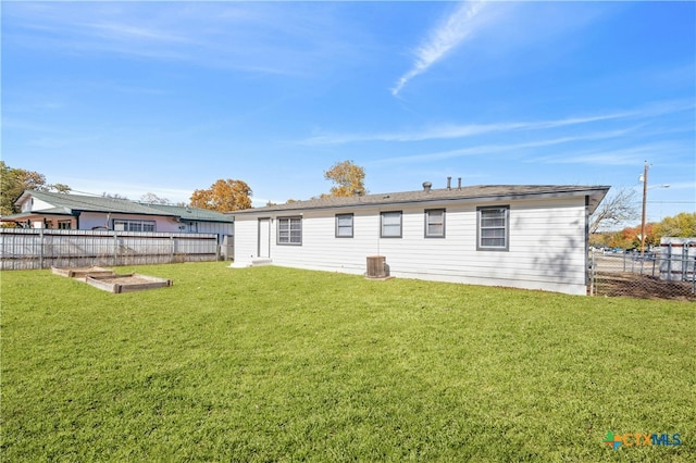 rear view of house with a lawn