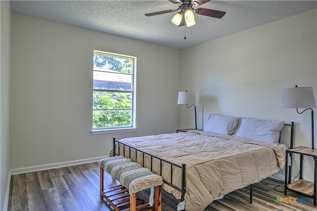 1614 Donna Ave, Copperas Cove, TX 76522 - bedroom featuring multiple windows, a textured ceiling, wood finished floors, baseboards, and ceiling fan