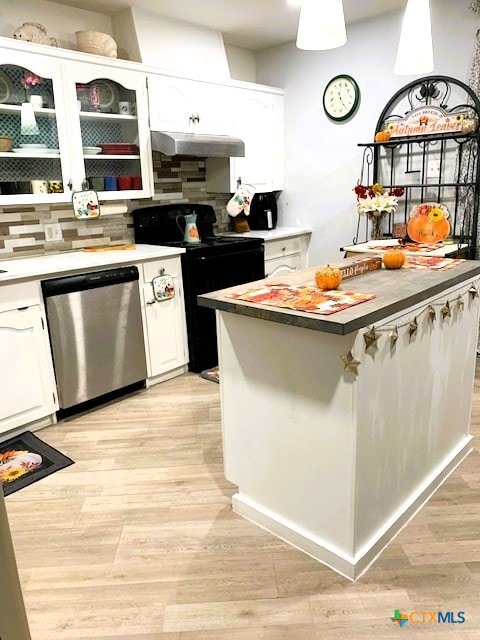 kitchen with extractor fan, white cabinetry, stainless steel dishwasher, and range with electric stovetop