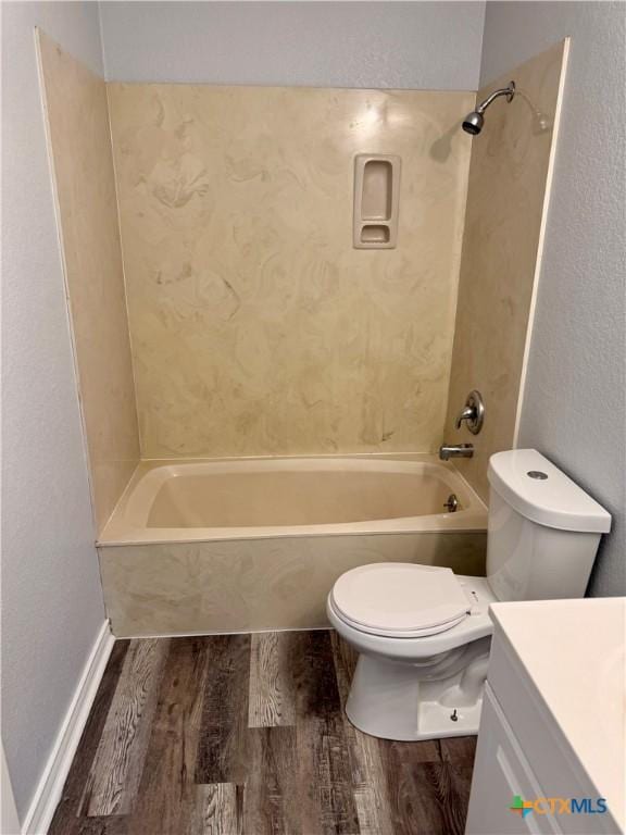 1037 N Guadalupe St, Seguin, TX 78155 - full bath with wood finished floors, vanity, toilet, and bathing tub / shower combination
