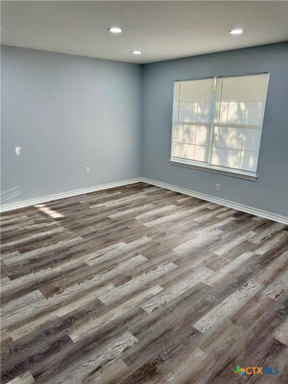 1037 N Guadalupe St, Seguin, TX 78155 - unfurnished room with wood finished floors, recessed lighting, and baseboards