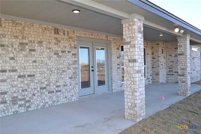 entrance to property featuring french doors and a patio area