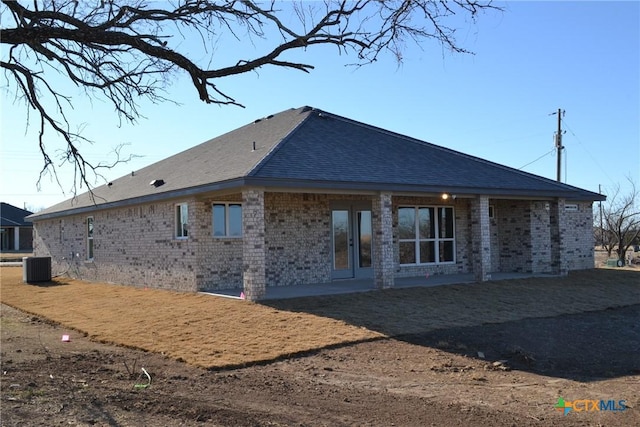 rear view of house featuring central air condition unit