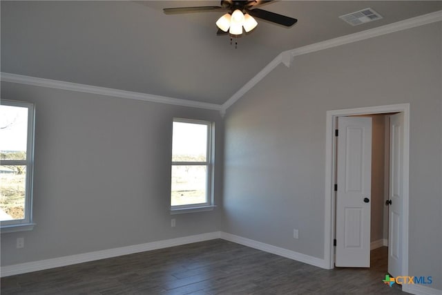 empty room with vaulted ceiling, ornamental molding, dark hardwood / wood-style floors, and ceiling fan