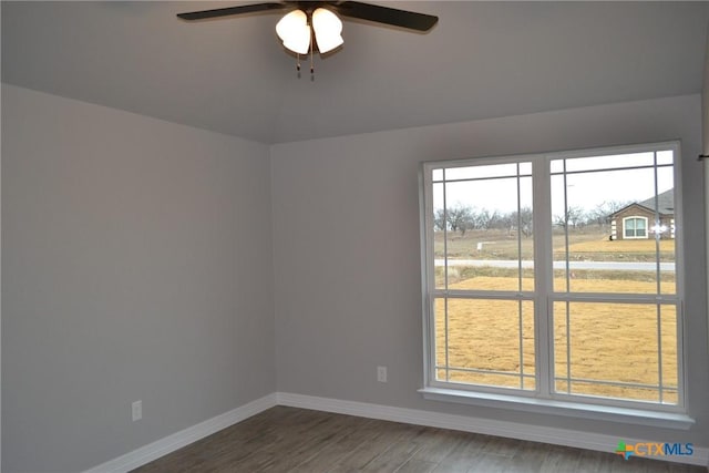 empty room featuring ceiling fan and dark hardwood / wood-style floors