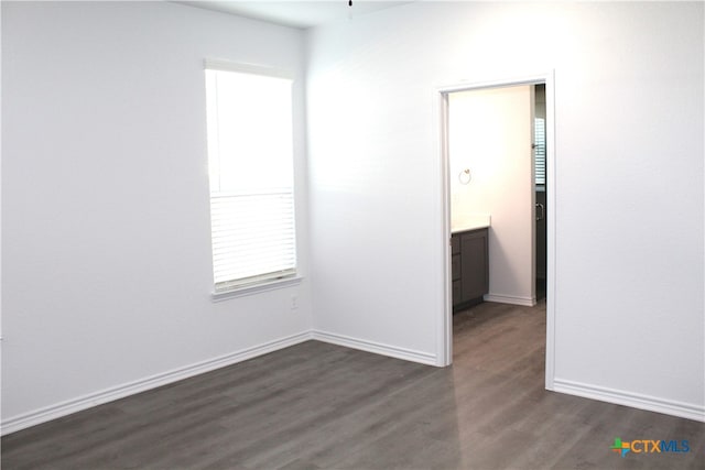 spare room featuring dark wood-type flooring