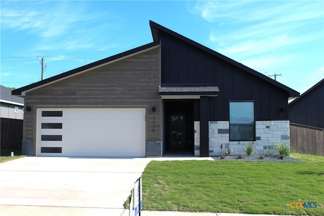 view of front of home featuring a garage and a front lawn