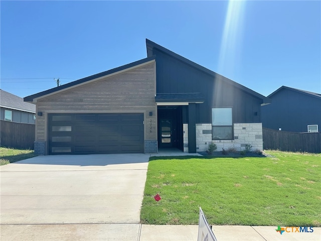 2226 Wooster St, Nolanville, TX 76559 - contemporary house featuring a front yard, an attached garage, fence, and driveway