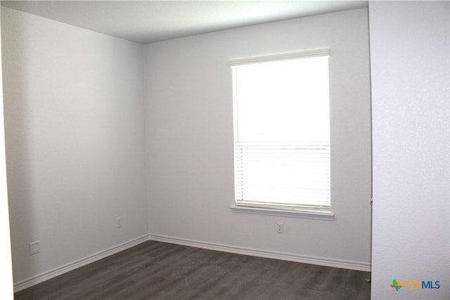 unfurnished room featuring dark hardwood / wood-style flooring