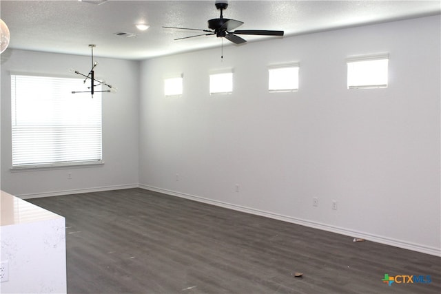 unfurnished room featuring ceiling fan, dark wood-type flooring, and a textured ceiling