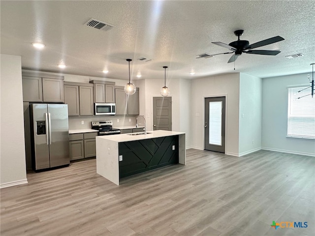 2226 Wooster St, Nolanville, TX 76559 - kitchen featuring light countertops, appliances with stainless steel finishes, light wood finished floors, and a sink