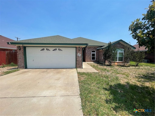 ranch-style house featuring brick siding, concrete driveway, an attached garage, and a shingled roof