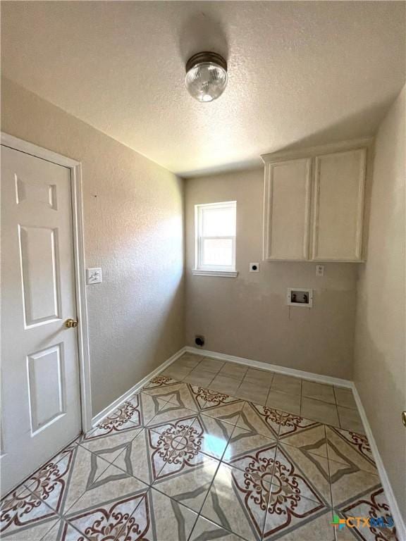 washroom featuring cabinet space, hookup for an electric dryer, light tile patterned floors, hookup for a washing machine, and a textured ceiling