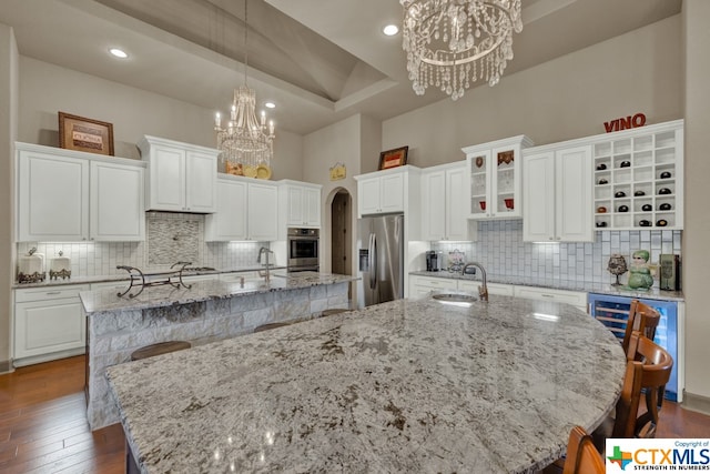 kitchen with a spacious island, appliances with stainless steel finishes, and white cabinetry