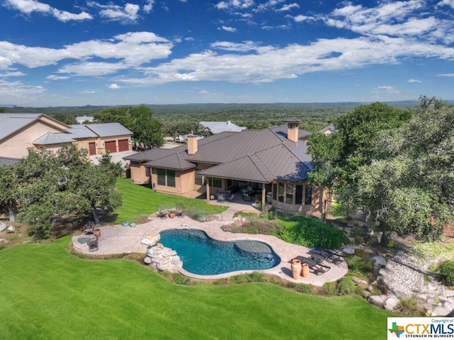 view of swimming pool with a patio and a lawn